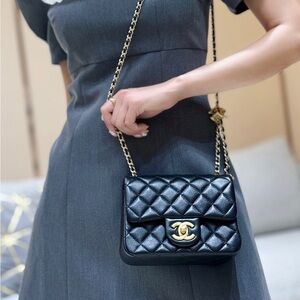 CHANEL Black Quilted Mini Flap Crossbody with Gold Hardware